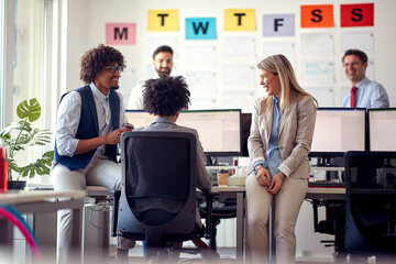 A group of employees chatting in the office. Employees, job, office
