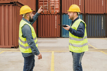 Industrial engineer people working at container cargo logistics terminal port - Focus on right man face