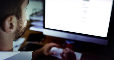 Putting in the work. High angle shot of a handsome young businessman working late in the office.