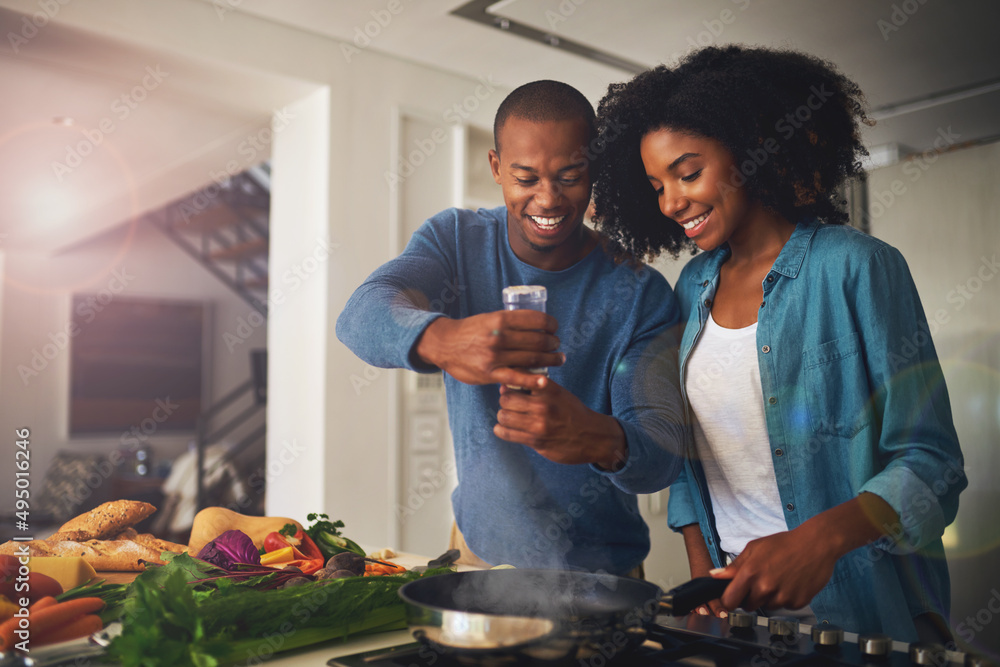 Poster some pepper goes a long way. shot of a cheerful young couple taking a photo of the ingredients of th