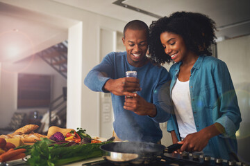 Some pepper goes a long way. Shot of a cheerful young couple taking a photo of the ingredients of...