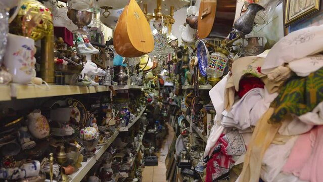 Shelves at a flea market filled with old antique items for sale
