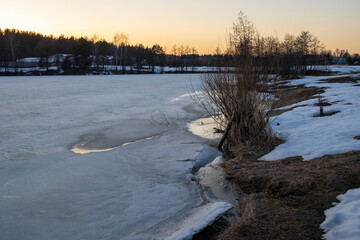Melting ice and snow. Spring landscape, evening forest with a river. The beginning of spring....
