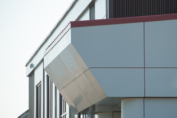 The exterior wall of a contemporary commercial style building with aluminum metal composite panels...