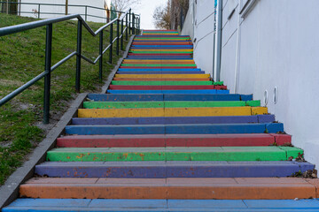  steps of colorful stairs with handrail going up