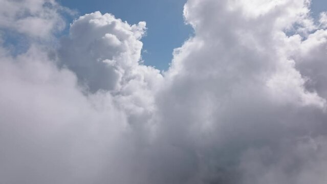 Camera rising above cinematic white thick fog above beautiful ocean clouds at sunrise. Cinematic drone aerial above endless sea of clouds until the horizon. Amazing nature landscape with blue sky 4K