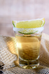 shot of Brazilian cachaça and tequila with lime sugar cane alcoholic drink