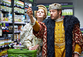 Not too royal to shop. A king and queen taking a selfie in their local supermarket.