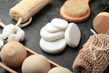 Bathing supplies with spa stones on dark background
