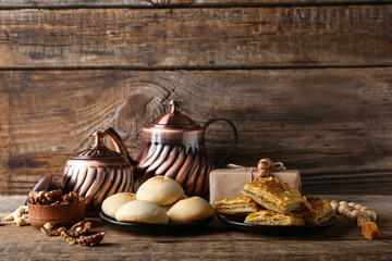 Fototapeta na wymiar Tasty Eastern sweets and tea on wooden background