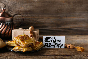Tasty Turkish baklava with gift and greeting card for Eid al-Fitr (Feast of Breaking the Fast) on...