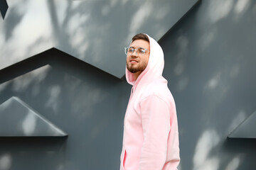 Young guy in stylish hoodie outdoors