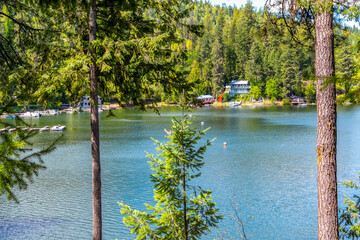 View from a hillside overlooking Newman Lake and waterfront homes and docks in Newman Lake, a suburb of Spokane, Washington USA. - obrazy, fototapety, plakaty