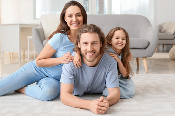 Young family on soft carpet at home