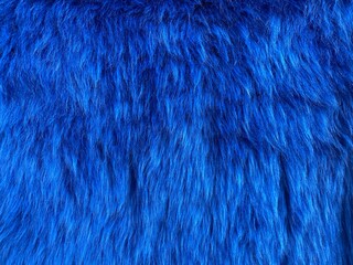Natural fur. Long hair fur for background or texture. Texture of fluffy fur for designers. Close-up fragment wool. Wool texture. Natural sheepskin rug background.