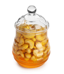 Jar of tasty cashew nuts with honey on white background