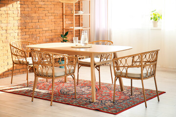Interior of modern dining room with table and vintage carpet