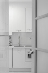 voyeur view of a white kitchen with matching appliances