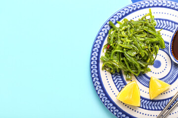 Plate with healthy seaweed salad on blue background © Pixel-Shot