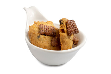 Fresh baked crispy cookie with choc chip, cashew nuts and chocolate textured cereal on white spoon with white background. Clipping path.	
