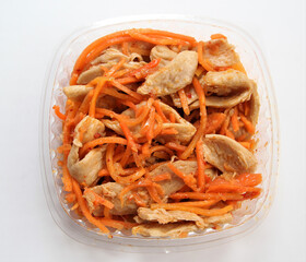 Soy meat salad with carrots. Salad in a disposable bowl.