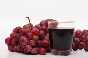 Red grapes photographed in a studio on a white background.