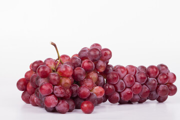 Red grapes photographed in a studio on a white background.