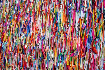 Religious ribbons with the inscription Remembrance of our Lady of Nazareth (Lembranca de Nossa Senhora de Nazaré). Believers attach them to fence of Cathedral of Our Lady of Grace in Belém, Brazil. - obrazy, fototapety, plakaty
