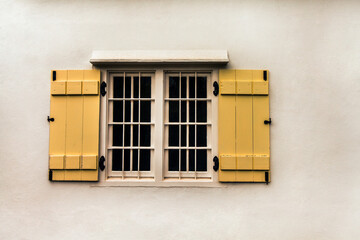 A room with a view.... Cropped shot of a window with yellow shutters.
