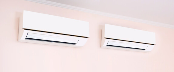 Close up air conditioner split type wall mounted in home room concepts of cool or heat or air cleaning filter and service repairing and air condition maintenance.