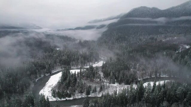Lowland Winter Fog in Snowy Mountain Valley Aerial View