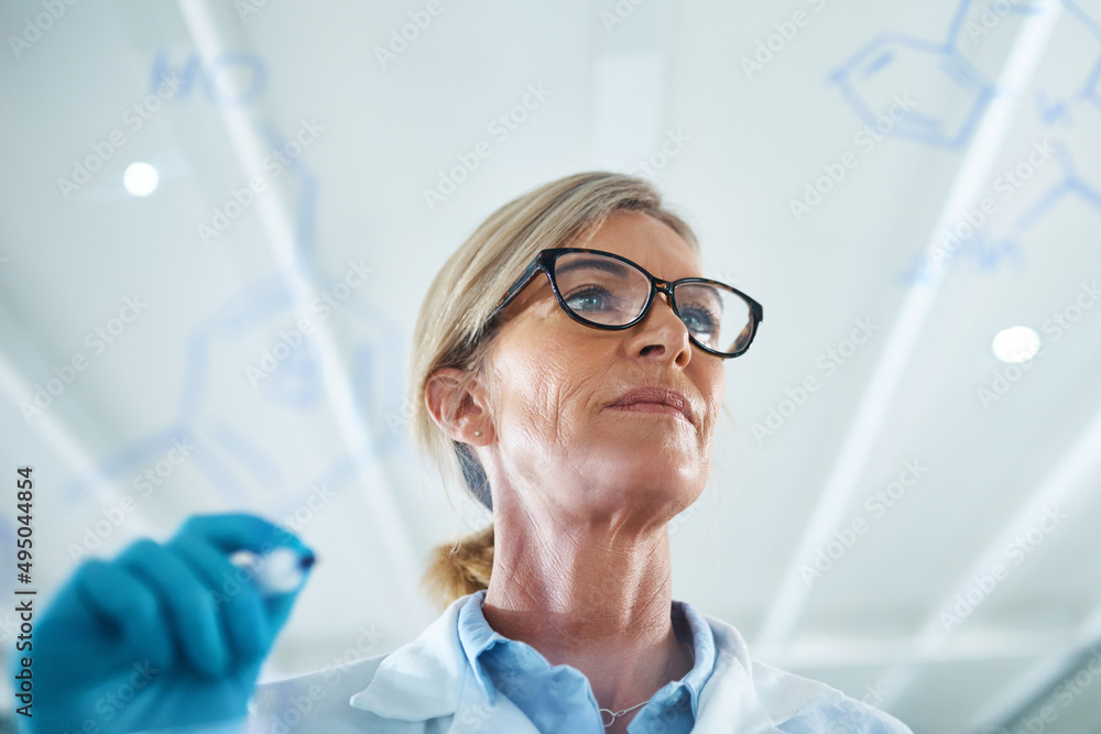 Poster science is one of the most important channels of knowledge. shot of a mature scientist drawing molec