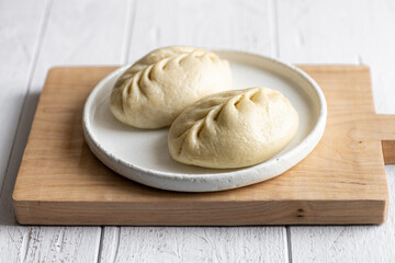 Traditional Korean steamed buns, pyanse or pigodi, on white wooden background, selective focus