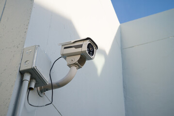 Outdoor CCTV camera security system on white wall building. Security and privacy concept.