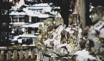 Snow on jizo little buddha statues in Japan