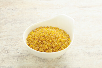 Raw bulgur in the bowl