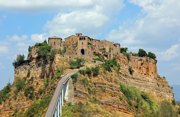 Ancient village on the hill called Civita di Bagnoregioin Central Italy and a long pedestrian bridge that connects it