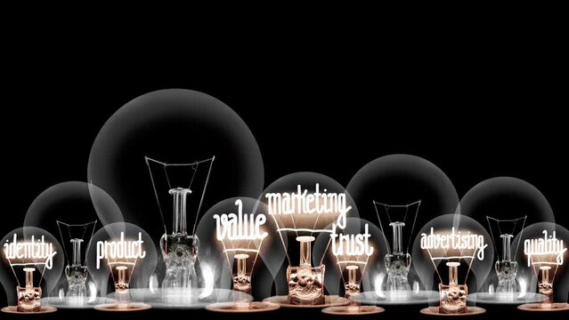 Light bulbs going from dark to light with Brand, Logo, Quality, Advertising and Marketing fiber text on black background. High quality 4k video.