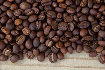 Roasted coffee beans on wooden background