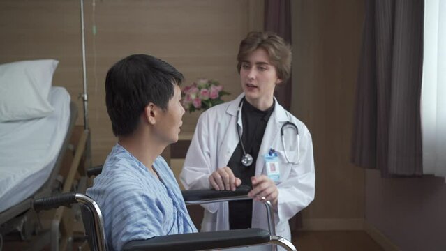 Caucasian white female doctor visiting and talking to senior Asian patient.