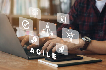 Person working on computer with icons of Agile development methodology concept on virtual screen....