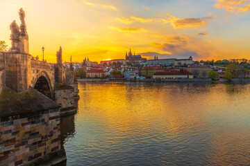 Fototapeta na wymiar One of the most famous Prague views of the Hradčany skyline, which is taken from Charles Bridge at sunset, which sets directly behind the castle.