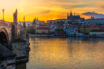 Fototapeta premium One of the most famous Prague views of the Hradčany skyline, which is taken from Charles Bridge at sunset, which sets directly behind the castle.