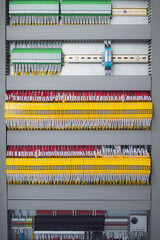 Wiring PLC Control panel with wires industrial factory.Wiring terminals in the electrical Cabinet. Electrical wires or cables are connected to electrical equipment