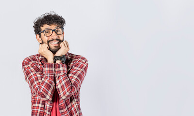 Handsome man in glasses smiling kindly, close up of smiling man touching his cheeks on isolated background, face of smiling friendly guy with hands on cheek