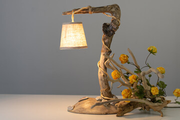 wooden table lamp made of driftwood with flowers