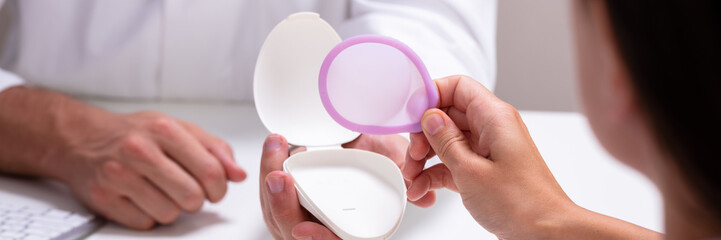 Gynecologist Consulting Woman On Diaphragm Contraception Method