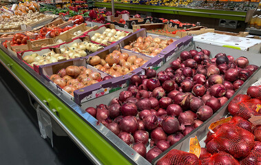 Lots of food on the counter in the supermarket. Vegetables, fruits. View from above.