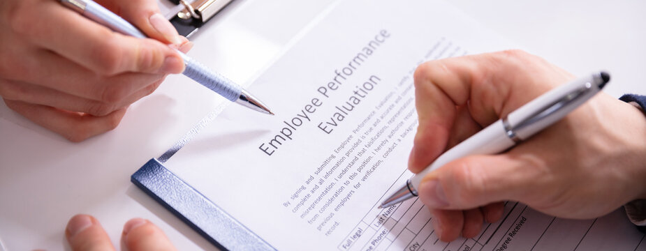 Person Filling Employee Performance Evaluation Form