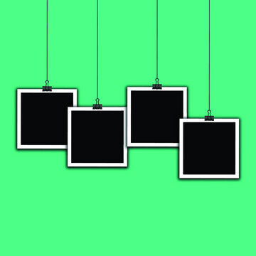 four hanging photo frames on green background Vector